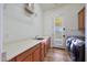 Laundry room with sink, storage, and modern washer and dryer at 2050 N 144Th Dr, Goodyear, AZ 85395