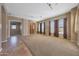 Open-concept living room with tile and carpet flooring and plenty of natural light at 2050 N 144Th Dr, Goodyear, AZ 85395