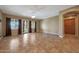 Spacious living room with tiled flooring, ceiling fan and access to the backyard at 2050 N 144Th Dr, Goodyear, AZ 85395