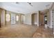 Open-concept living room with tile and carpet flooring and natural light at 2050 N 144Th Dr, Goodyear, AZ 85395