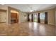 Bright living room with tile flooring, ceiling fan, and built-in desk nook at 2050 N 144Th Dr, Goodyear, AZ 85395