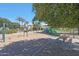 Community playground with swings, slides, picnic tables, and a shade structure, perfect for families at 2050 N 144Th Dr, Goodyear, AZ 85395