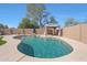 Backyard pool features an umbrella and covered patio, set in a block-walled garden at 2050 N 144Th Dr, Goodyear, AZ 85395