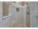 Shower with mosaic tile flooring, a built in bench, and modern fixtures at 2050 N 144Th Dr, Goodyear, AZ 85395