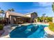 Stunning backyard featuring a pool, spa, outdoor seating area, and mature palm trees at 21041 N 61St Dr, Glendale, AZ 85308