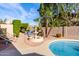 Relaxing backyard featuring a pool, water fountain, and beautiful desert landscaping at 21041 N 61St Dr, Glendale, AZ 85308