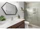 Modern bathroom with a vanity, mirror, and tiled walk-in shower at 21041 N 61St Dr, Glendale, AZ 85308