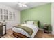 Bright bedroom featuring a ceiling fan, light hardwood floors, and a large window for natural light at 21041 N 61St Dr, Glendale, AZ 85308