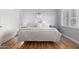 This bedroom features natural light, hardwood floors, and a neutral color palette at 21041 N 61St Dr, Glendale, AZ 85308