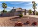 Rear view of a single-story home with desert landscaping and a fenced yard at 21041 N 61St Dr, Glendale, AZ 85308