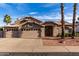 Charming single-story home featuring a three-car garage, desert landscaping, and a tile roof at 21041 N 61St Dr, Glendale, AZ 85308