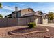 Rear view of a single-story home with desert landscaping and a fenced yard at 21041 N 61St Dr, Glendale, AZ 85308