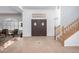 Bright foyer with tiled floor, decorative mosaic, a staircase, and double doors at 21041 N 61St Dr, Glendale, AZ 85308