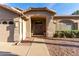 Close up shot of the front entrance and facade of a single-story home with desert landscaping at 21041 N 61St Dr, Glendale, AZ 85308