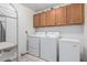 Functional laundry room with washer, dryer, and storage cabinets at 21041 N 61St Dr, Glendale, AZ 85308