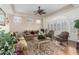 Traditional living room with plantation shutters, plush seating, and decorative rug at 21041 N 61St Dr, Glendale, AZ 85308