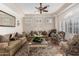 Traditional living room with plantation shutters, plush seating, and decorative rug at 21041 N 61St Dr, Glendale, AZ 85308