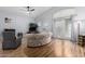 This living room boasts large windows, hardwood floors, and lots of natural light at 21041 N 61St Dr, Glendale, AZ 85308