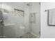 This walk-in shower features updated tilework, modern fixtures, and a rainfall shower head at 21041 N 61St Dr, Glendale, AZ 85308