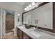 Beautiful bathroom with double sinks, granite countertops, and tiled shower at 21613 N Sunset Dr, Maricopa, AZ 85139