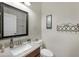 Cozy half bathroom with granite countertops, stylish sink, and decorative mirror at 21613 N Sunset Dr, Maricopa, AZ 85139