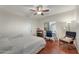 Sunlit bedroom with a cozy chair, comfortable bed, work desk, and open window at 21613 N Sunset Dr, Maricopa, AZ 85139