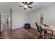 Bright bedroom with hardwood floors, ceiling fan, bean bag chair and work desk at 21613 N Sunset Dr, Maricopa, AZ 85139