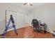 Comfortable bedroom featuring a work desk, rolling chair, and closet at 21613 N Sunset Dr, Maricopa, AZ 85139