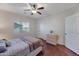 Comfortable bedroom with hardwood floors, neutral walls, and good natural light for relaxation at 21613 N Sunset Dr, Maricopa, AZ 85139