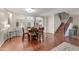 Elegant dining area featuring hardwood floors, a wooden table with seating for six, and stairway access at 21613 N Sunset Dr, Maricopa, AZ 85139