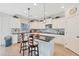 Modern kitchen with white cabinetry, granite countertops, stainless steel appliances, and a large island at 21613 N Sunset Dr, Maricopa, AZ 85139