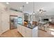 Open-concept kitchen with stainless steel appliances, a central island, and an adjacent dining area at 21613 N Sunset Dr, Maricopa, AZ 85139
