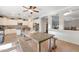 Bright, open kitchen with dining table and bench; features stainless appliances, kitchen island, and ample cabinet space at 21613 N Sunset Dr, Maricopa, AZ 85139