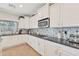 Well-appointed kitchen featuring black granite countertops, stainless steel appliances, and a decorative backsplash at 21613 N Sunset Dr, Maricopa, AZ 85139