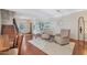 Inviting living room showcasing hardwood floors, staircase, natural light, and neutral color scheme at 21613 N Sunset Dr, Maricopa, AZ 85139