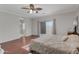 Large main bedroom with wood floors, neutral tones, walk-out slider, and a ensuite bathroom at 21613 N Sunset Dr, Maricopa, AZ 85139