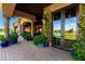 Covered back patio with brick pavers, potted plants, and reflecting french doors at 21962 E Diana Way, Queen Creek, AZ 85142
