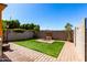 Paver patio and artificial turf backyard with a decorative water fountain and mature trees at 21962 E Diana Way, Queen Creek, AZ 85142