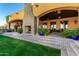 An entertainer's backyard with fireplace, patio, and view of the pool and lawn at 21962 E Diana Way, Queen Creek, AZ 85142