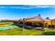 Beautiful backyard with a pool, fountain, and green lawn offering a luxurious outdoor living experience at 21962 E Diana Way, Queen Creek, AZ 85142