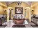 Elegant bathroom featuring a copper soaking tub, chandelier, and stone flooring at 21962 E Diana Way, Queen Creek, AZ 85142