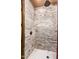 Spacious walk-in shower with neutral stone tile surround at 21962 E Diana Way, Queen Creek, AZ 85142