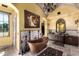 Elegant bathroom with a copper soaking tub, stylish lighting, and dual vanities at 21962 E Diana Way, Queen Creek, AZ 85142