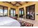 Bedroom with vaulted ceilings, decorative rug, and access to the yard through glass doors at 21962 E Diana Way, Queen Creek, AZ 85142