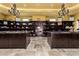 Spacious walk-in closet with built-in shelving, chandeliers and stone floors at 21962 E Diana Way, Queen Creek, AZ 85142