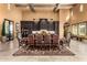 An elegant dining room featuring a large table, chairs, and decorative chandeliers at 21962 E Diana Way, Queen Creek, AZ 85142