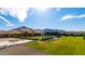 Luxury estate with a spacious backyard, featuring a pool, tall trees, and mountain views at 21962 E Diana Way, Queen Creek, AZ 85142
