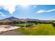 A sprawling estate features a large backyard, sparkling pool, and stunning mountain views in the distance at 21962 E Diana Way, Queen Creek, AZ 85142