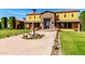 Grand two-story home with stone accents, manicured lawn, fountain and patterned brick driveway at 21962 E Diana Way, Queen Creek, AZ 85142