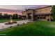 Exterior shot of property at sunset showcasing stone entry and lush landscaping at 21962 E Diana Way, Queen Creek, AZ 85142